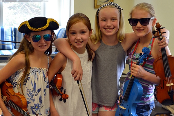 Young girls posing with their violins