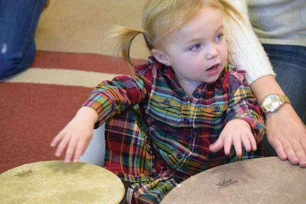 Young child playing a drum