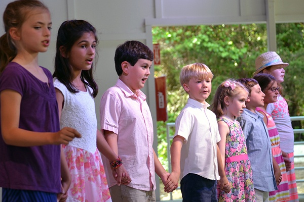 Young children singing.