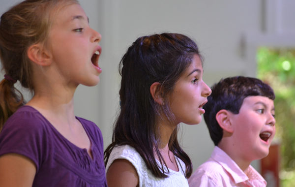 Young children singing.