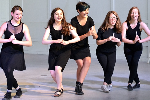 Teens performing a musical dance number.