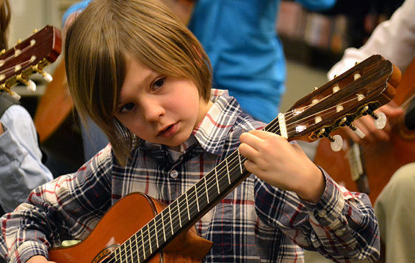 Child playing guitar