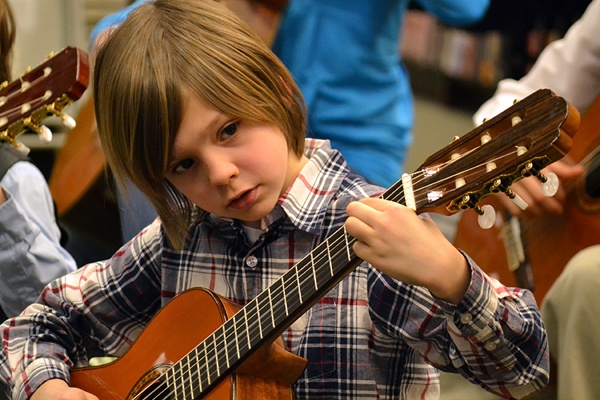 Child playing guitar