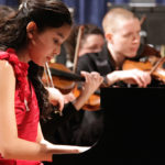 piano student playing piano concerto