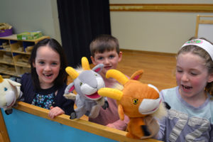 Children playing with hand puppets.