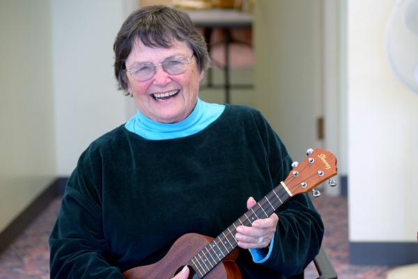 Woman playing a ukulele.