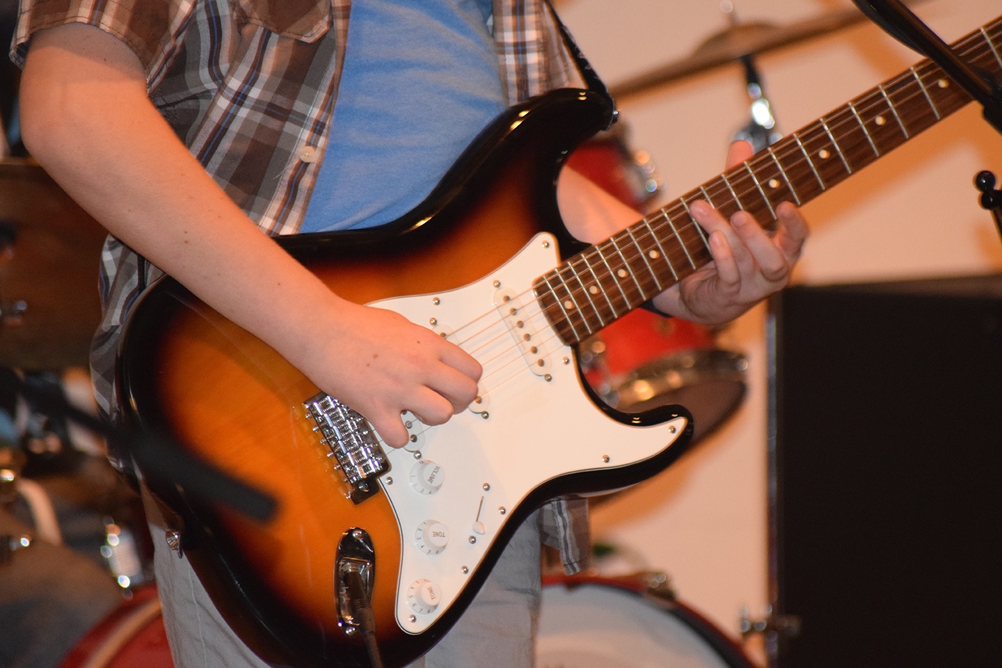 Middle School student playing an electric guitar