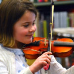 Young Suzuki violin student performing