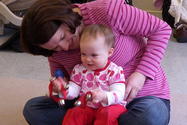 Mother and toddler playing with shakers