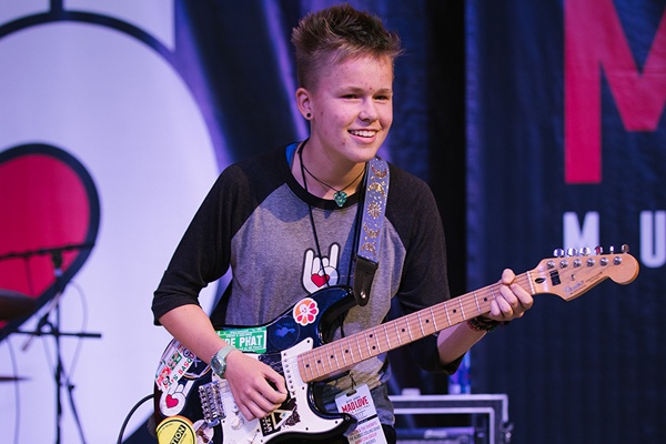 Teen playing electric guitar