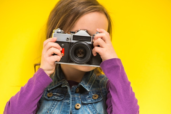 Little girl taking a photo.