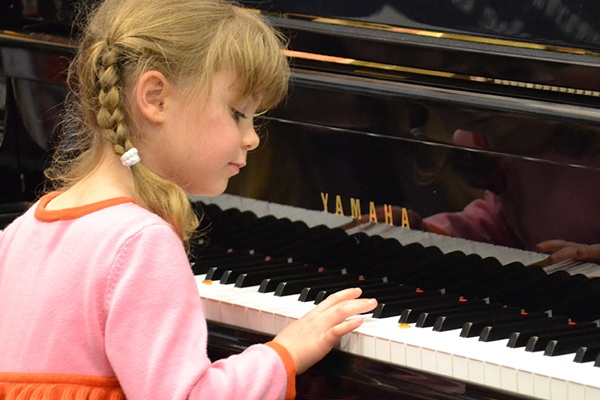 young girl playing the piano